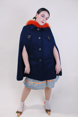 Women's vintage 1960's navy blue wool material poncho with slits for arms, gold hardware and gold buttons. Fully lined.