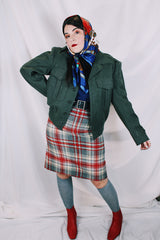 Women's or men's vintage cropped army jacket in a dark green grey wool material. Has a button closure and two front chest pockets.