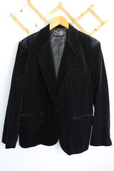 Women's vintage 1970's The Chaus Woman label long sleeve black velvet blazer in a cotton and rayon blend material. One button closure, two pockets, and fully lined.