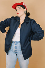 Men's or women's vintage 1970's Unitog Company, Union Made in USA label size large long sleeve navy blue station jacket that zips up the front with red nylon liner.