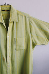 Men's vintage 1960's Sears label short sleeve button up shirt with collar and one left chest pocket in a lime green striped cotton material.