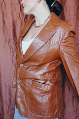 Women's or men's vintage 1970's Cresco label camel brown colored leather blazer jacket with two button closure and two front pockets.