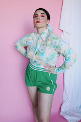 Women's vintage 1970's long sleeve button up blouse with collar in an overall yellow, green, and blue floral print. Acetate and Nylon blend material.