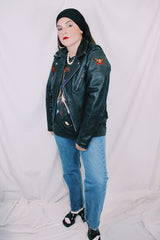 Men's or women's vintage 1970's Harley-Davidson label long sleeve black leather motorcycle jacket with silver hardware and patches.