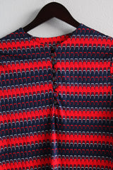 Women's vintage 1970's long sleeve red and navy colored striped zig zag top with half button front closure in a slinky polyester material.