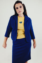 vintage three piece knit set with blue cropped jacket, midi skirt, and sleeveless embroidered top front