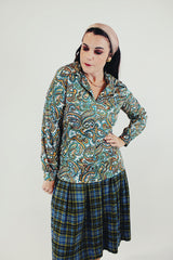 Long sleeve green and blue paisley printed blouse with double lapel front untucked