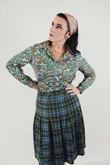 Long sleeve green and blue paisley printed blouse with double lapel front tucked in