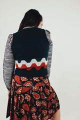 forest green vintage women's acrylic sweater vest with orange and white stripe detail back