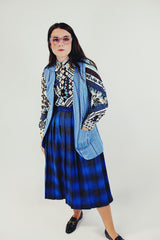 1970's vintage light blue best with no closure and two front pockets and striped pattern throughout