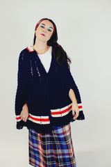 women's vintage navy crochet poncho with red and white stripes around hem with buttons and collar front