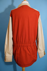 Women's or men's vintage 1980's Aspen label long sleeve zip up lightweight windbreaker jacket in tan and burn orange.