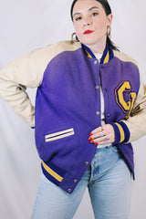 Women's or men's vintage 1960's Shields, Sporting Goods Inc., Vancouver, Washington label long sleeve wool and leather varsity letterman jacket in purple, cream, and yellow colors.