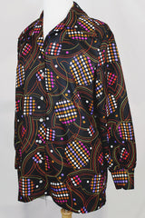 Women's vintage 1970's long sleeve button up blouse in black with all over multi-colored abstract print in a lightweight polyester material.