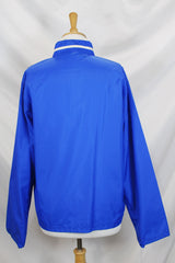 Women's or men's vintage 1970's Zody's Quality Plus, Made in Japan label long sleeve bright blue nylon zip up windbreaker with white and red trim.