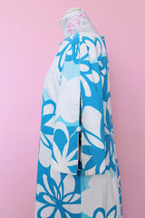 Women's vintage 1970's Polynesian Casuals, Honolulu 3/4 arm length midi length blue and white Hawaiian print dress in cotton material with cut out details on sleeves.