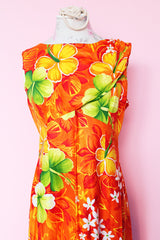 Women's vintage 1970's ears Hawaiian Fashions label sleeveless cotton material ankle length orange dress with all Hawaiian floral print.