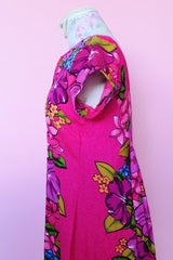 Women's vintage 1960's Skirts & Blouses Specialty Shop Honolulu label short sleeve ankle length bright pink cotton material dress with all over Hawaiian floral print.
