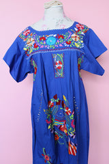 Women's vintage 1970's short sleeve bright blue cotton dress with all over multicolored floral and parrot print embroidery
