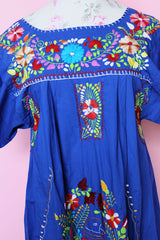 Women's vintage 1970's short sleeve bright blue cotton dress with all over multicolored floral and parrot print embroidery