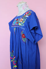 Women's vintage 1970's short sleeve bright blue cotton dress with all over multicolored floral and parrot print embroidery