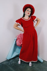 Women's vintage 1970's short sleeve flutter sleeve red velvet ankle length dress with white applique trim.