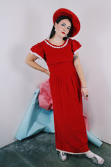 Women's vintage 1970's short sleeve flutter sleeve red velvet ankle length dress with white applique trim.