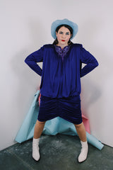 Women's vintage 1980's long sleeve knee length drapey purple slinky polyester dress with beaded trim neckline.