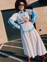 Men's or women's vintage 1970's long sleeve light blue polyester button up shirt with very pointy dagger collar and puff sleeves.