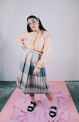 long sleeve peach colored blouse with ruffle front and ruffle neck vintage 1980's