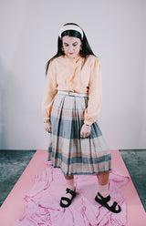 long sleeve peach colored blouse with ruffle front and ruffle neck vintage 1980's