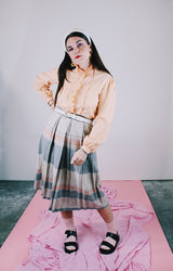 long sleeve peach colored blouse with ruffle front and ruffle neck vintage 1980's