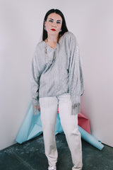 Women's vintage 1970's Saks Alley label long sleeve silver metallic blouse with fringe trim on cuffs and hem