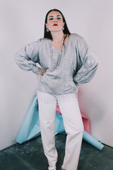 Women's vintage 1970's Saks Alley label long sleeve silver metallic blouse with fringe trim on cuffs and hem