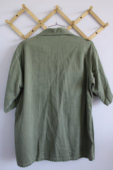 Men's vintage 1960's Guaranteed Trooper Fatigues label short sleeve army green button up shirt or jacket with US Air Force patches all over.