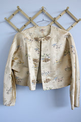 Women's vintage 1960's Dynasty Trade Mark label long sleeve cropped satin silk like robe jacket with all over print and fabric closures.