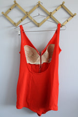 Women's vintage 1960's Catalina, California, USA label sleeveless one piece bright orange swimsuit with brass half zipper closure in the front.