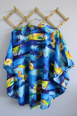 Women's vintage 1980's Made in Hawaii short sleeve wide cape blouse in all over blue Hawaiian print.