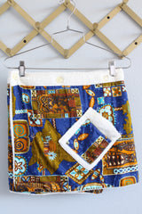 Women's vintage 1970's Go Barefoot Paradise, Honolulu, Hawaii label mini length wrap skirt in white towel material with cotton Hawaiian print fabric on top