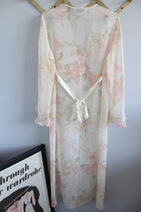 Women's vintage 1980's Valerie Stevens label long sleeve cream sheer lingerie robe with pink floral print, ruffle sleeves, and a tree button closure.