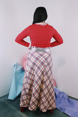Women's vintage 1970's ankle length maxi skirt in acrylic material. White with red, navy, and silver metallic plaid print all over