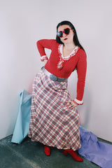 Women's vintage 1970's ankle length maxi skirt in acrylic material. White with red, navy, and silver metallic plaid print all over