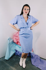 Women's vintage 1980's matching periwinkle purple dress and jacket set. Jacket is open with 3/4 arm length. Dress has cinched waist, short sleeves, and a double lapel neckline