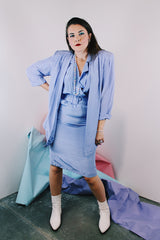 Women's vintage 1980's matching periwinkle purple dress and jacket set. Jacket is open with 3/4 arm length. Dress has cinched waist, short sleeves, and a double lapel neckline