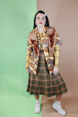 Women's vintage 1970's wool material plaid printed pleated knee length high waisted skirt. Olive green with tan, cream, and burnt orange plaid