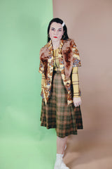 Women's vintage 1970's wool material plaid printed pleated knee length high waisted skirt. Olive green with tan, cream, and burnt orange plaid