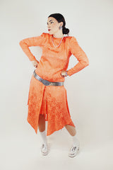 long sleeve orange silk dress with polka dot print and asymmetrical hem vintage 1980's