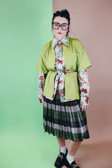 Women's vintage 1960's wool material pleated knee length skirt in brown, green, and orange all over plaid print