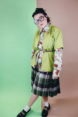 Women's vintage 1960's wool material pleated knee length skirt in brown, green, and orange all over plaid print