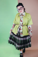 Women's vintage 1960's wool material pleated knee length skirt in brown, green, and orange all over plaid print